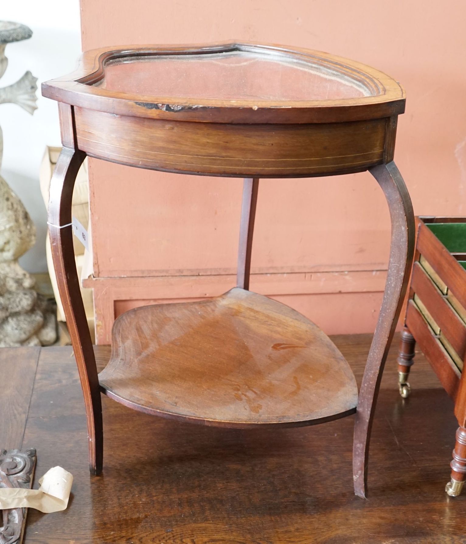 An Edwardian mahogany shield shaped bijouterie table, width 50cm, depth 59cm, height 72cm